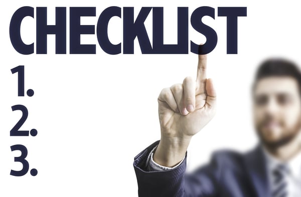 Business man pointing the text Checklist.jpeg