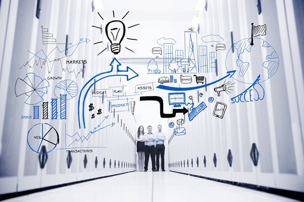 Colleagues standing in a data center in front of drawings of charts-1