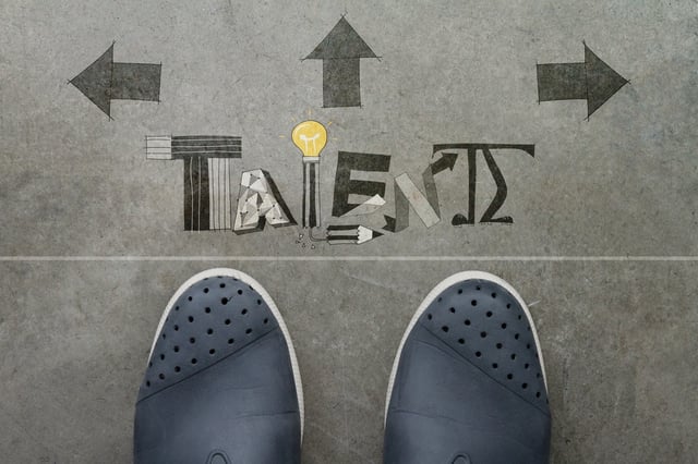 Hand drawn TALENT design word on front of business man feet as concept.jpeg