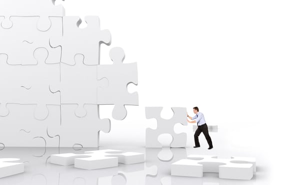 business man making a puzzle isolated over a white background